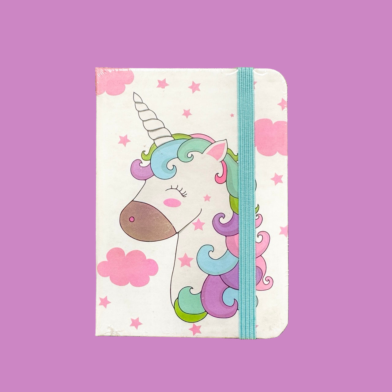 Notebook with a colorful unicorn design on a purple background