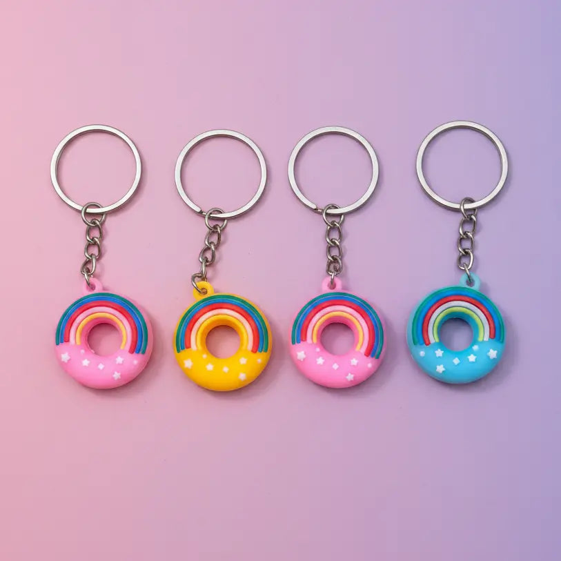 round keychains with rainbows on a pink and purple background