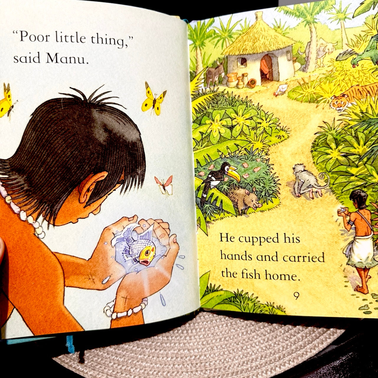 a scene where the boy carries the little fish in his hands to his village.