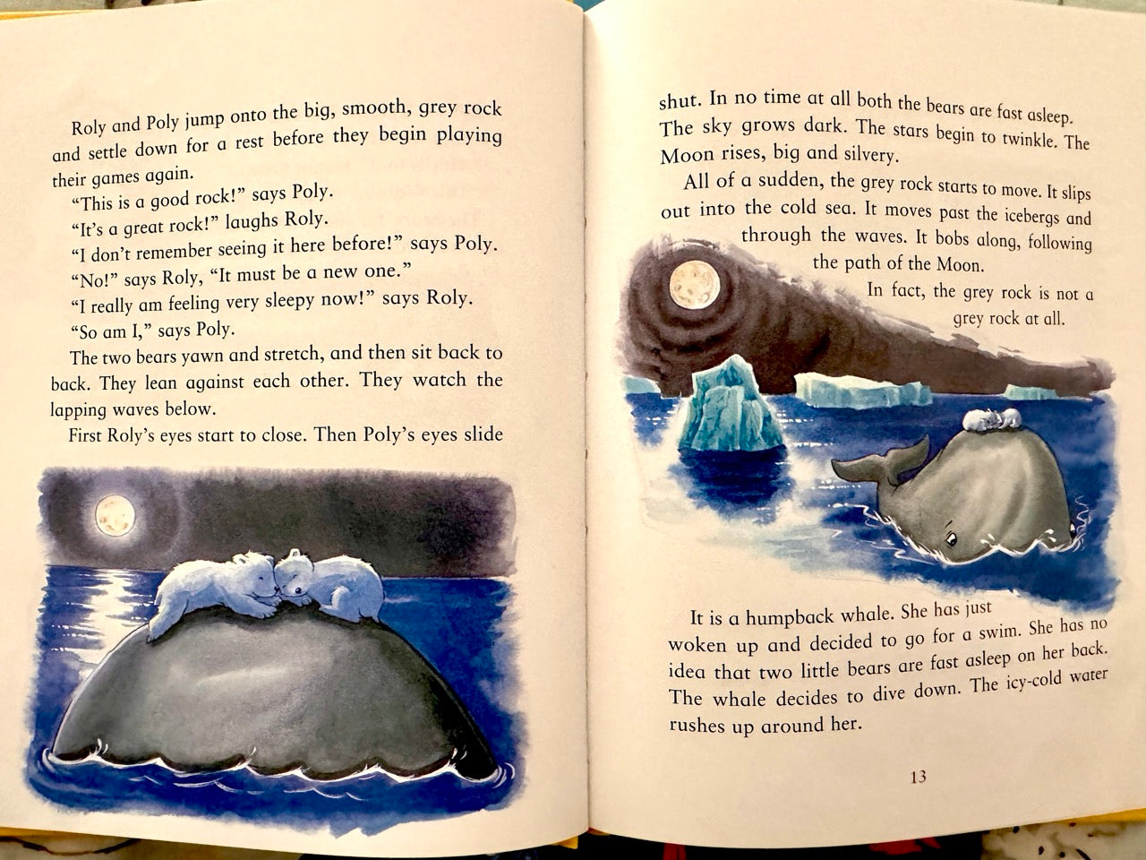 Open book with illustrations of bears and a whale in a nighttime setting.