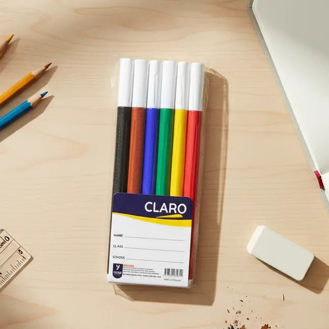 pack of colored markers on a light wood table with other stationery items