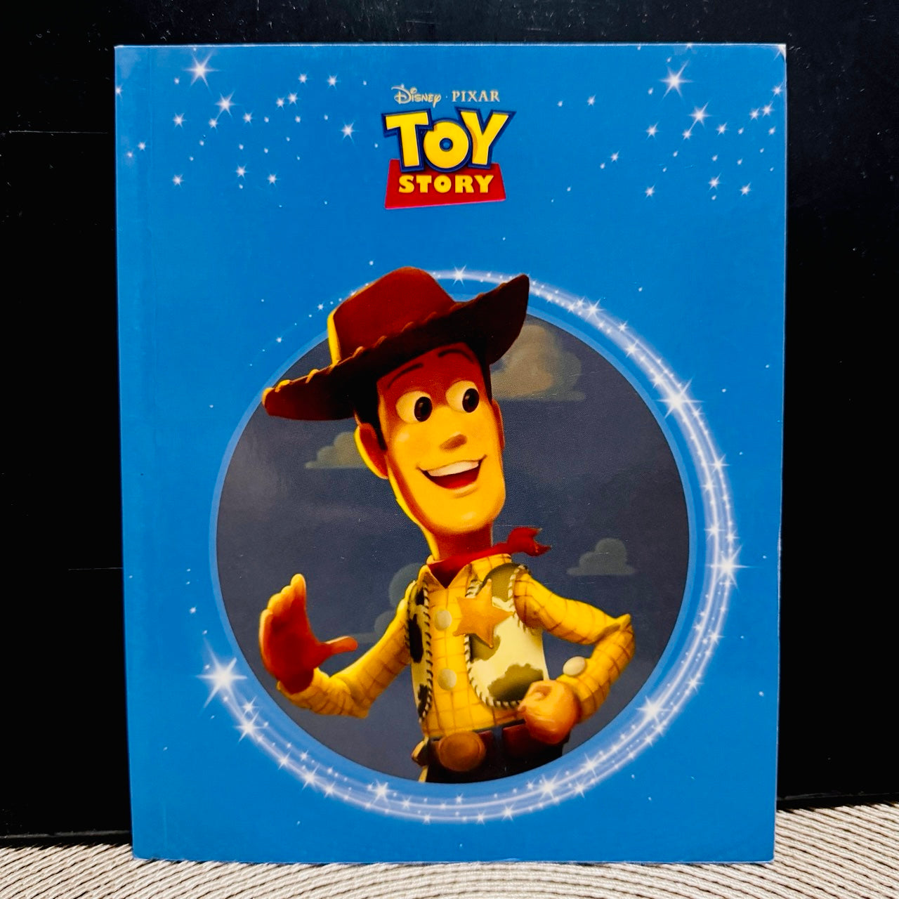 Toy Story book cover with Woody on a blue background