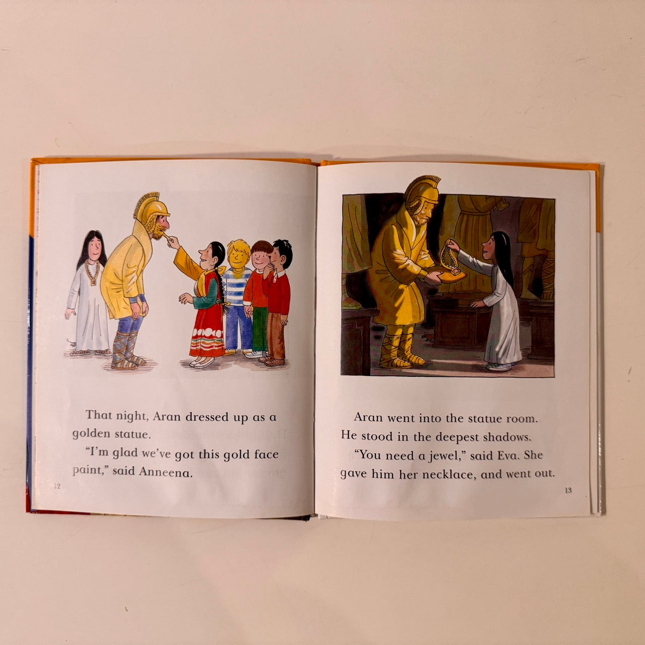 Open book with illustrated scenes and text on a white background