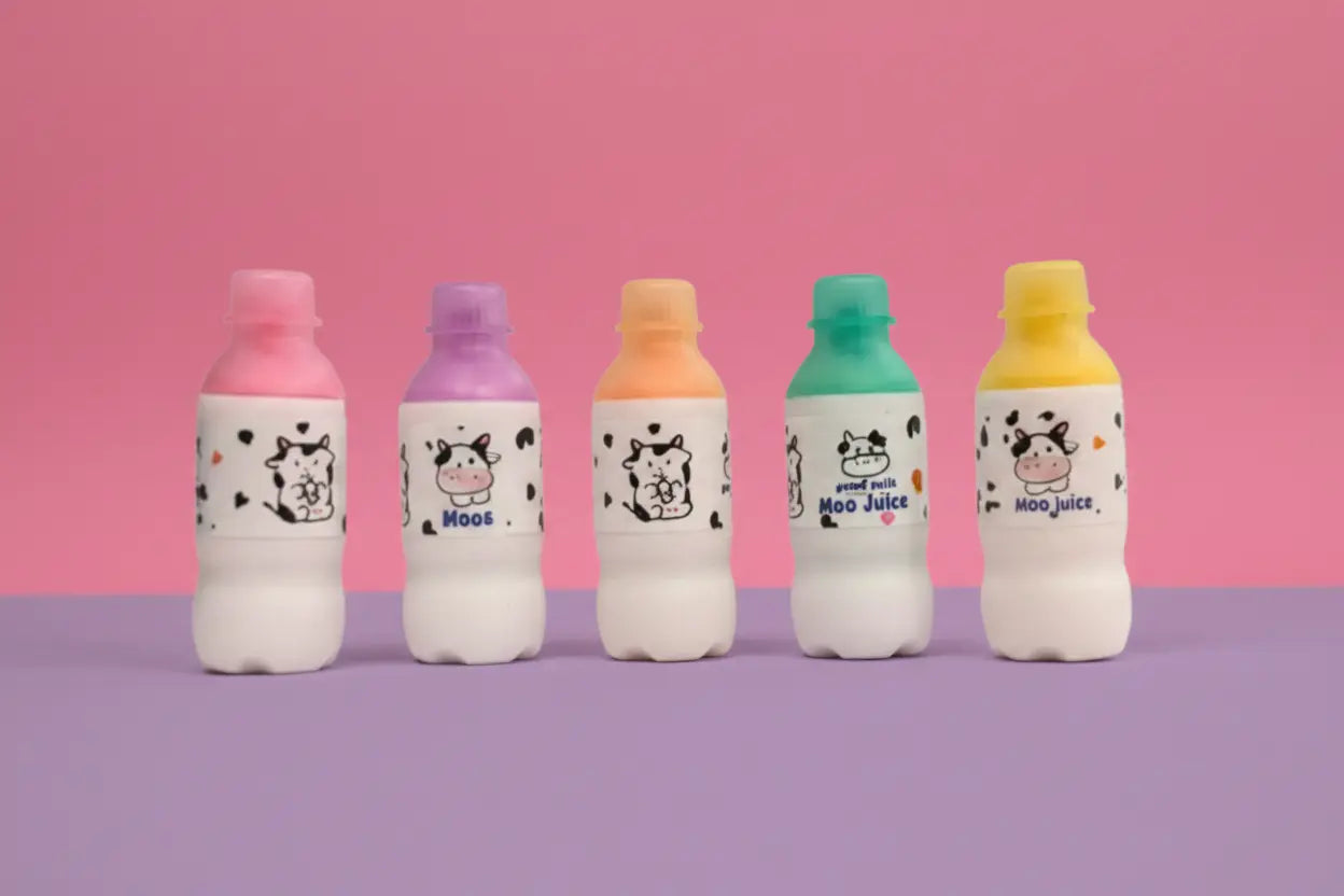 Five colorful bottles with cow-themed labels on a pink and purple gradient background