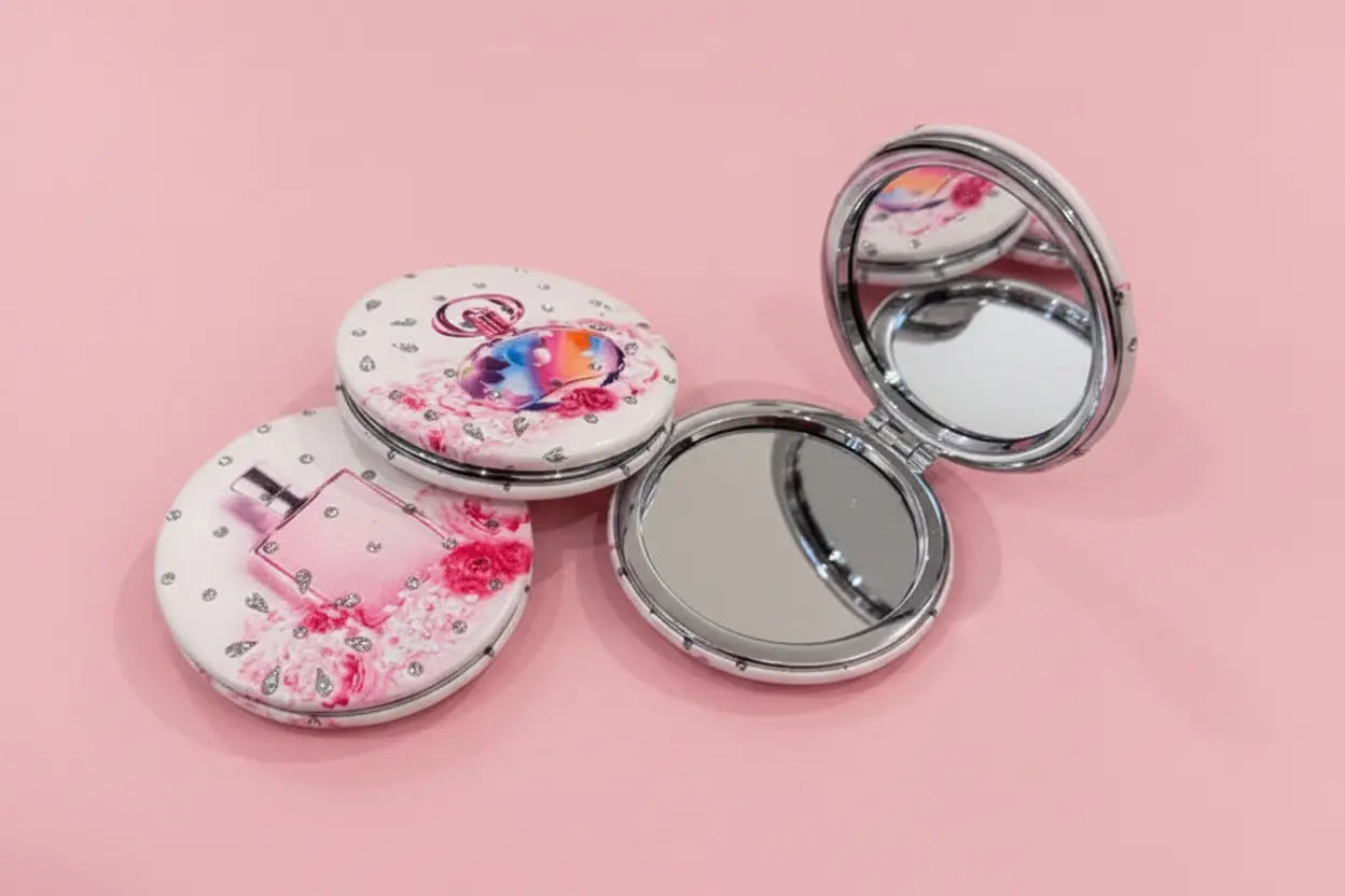 Compact mirror with floral design on a pink background