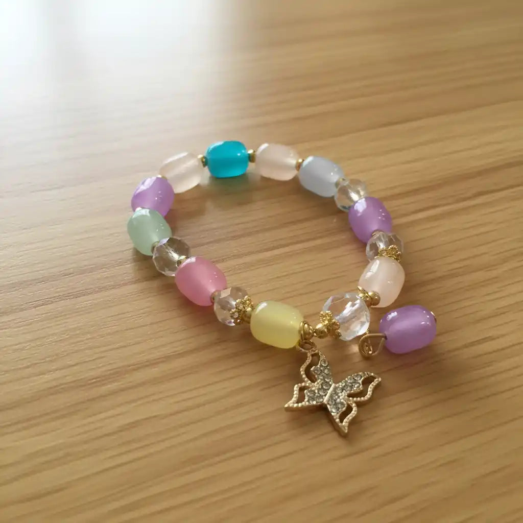 Beaded bracelet with a butterfly charm on a wooden surface