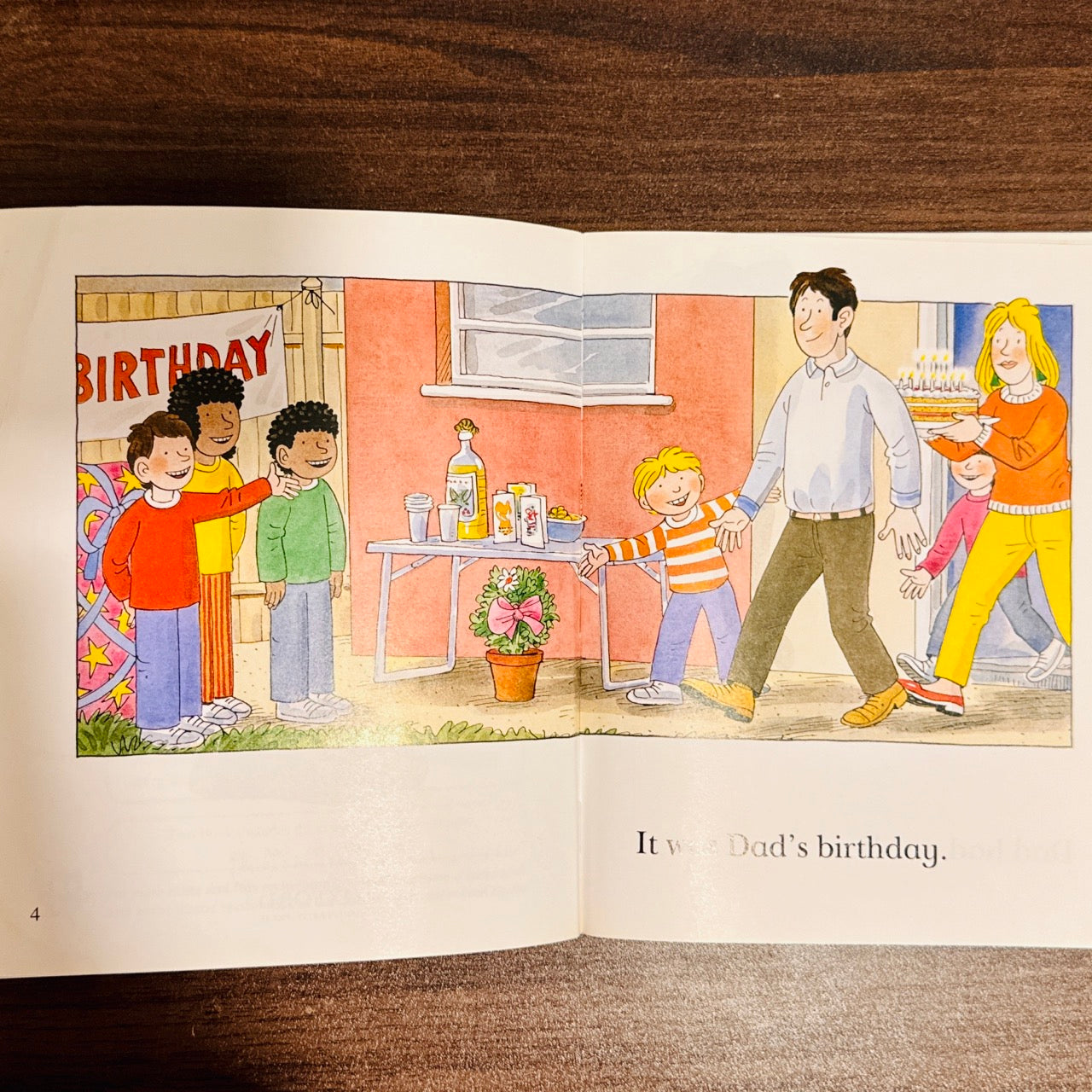 Illustrated book page showing a birthday celebration with children and adults.