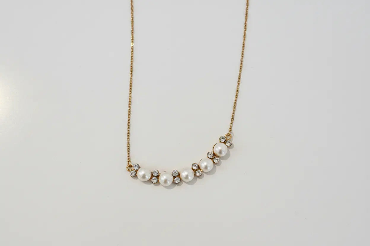 Pearl necklace on a light gray background