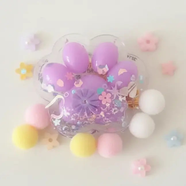 Decorative phone case with purple paw print design surrounded by colorful beads on a light background