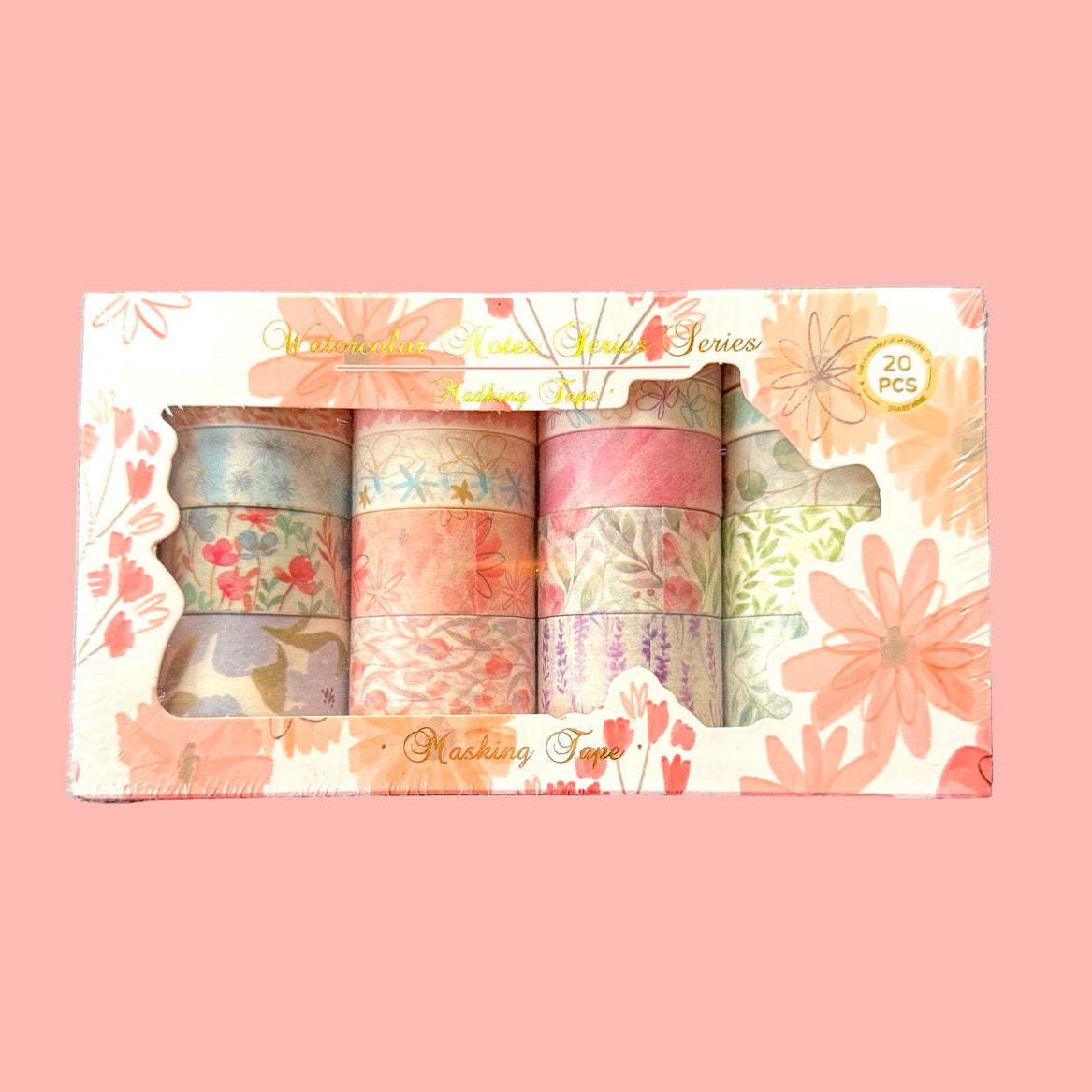 Set of washi tape rolls in a decorative box with floral designs on a pink background