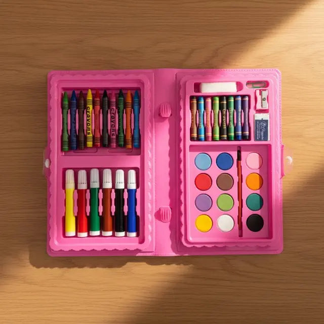 Pink art set with crayons, markers, and paint on a wooden surface