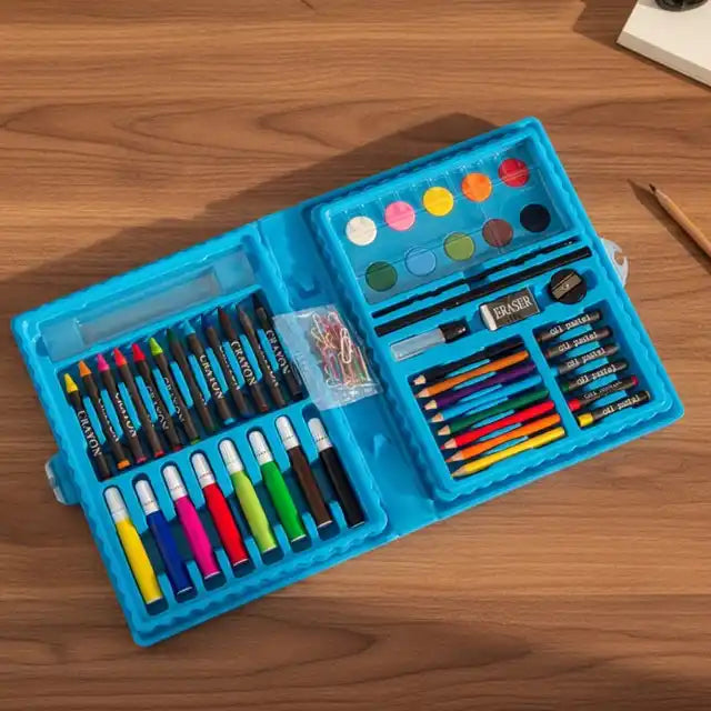 Art supply set with crayons, markers, and paint on a wooden surface