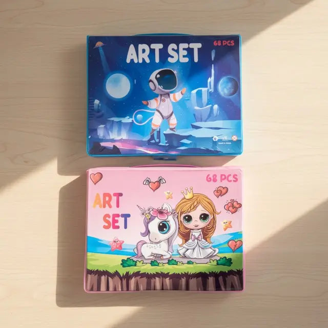 Two art set packages on a wooden surface, one with an astronaut design and the other with a princess and unicorn design.