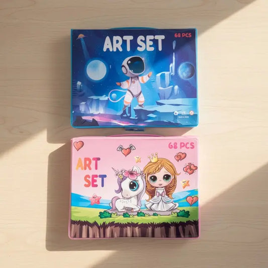 Two art set packages on a wooden surface, one with an astronaut design and the other with a princess and unicorn design.