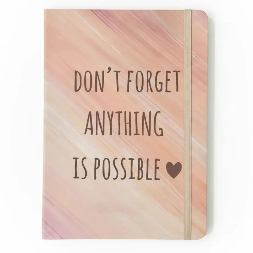 Notebook with motivational quote on a pastel gradient background