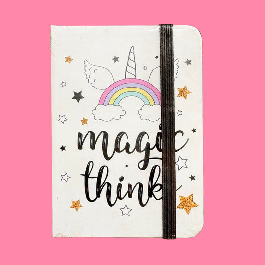 Notebook with unicorn, rainbow, and cloud design on a pink background