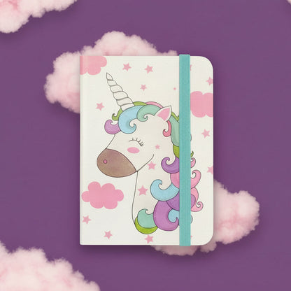 Notebook with a unicorn design on a purple background with pink clouds