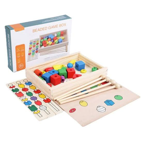 Wooden beaded game box with colorful beads and accessories on a white background