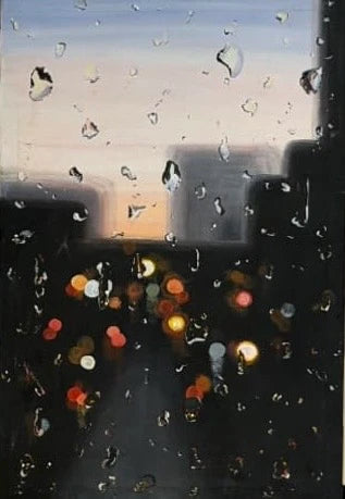 raindroplets on a windshield of a car looking out to a busy street on a morning