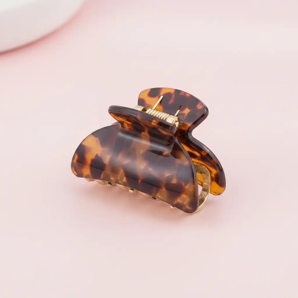 Tortoiseshell hair clip on a pink background