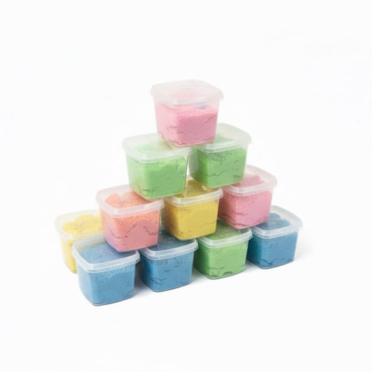 Stack of small containers filled with colorful sand on a white background