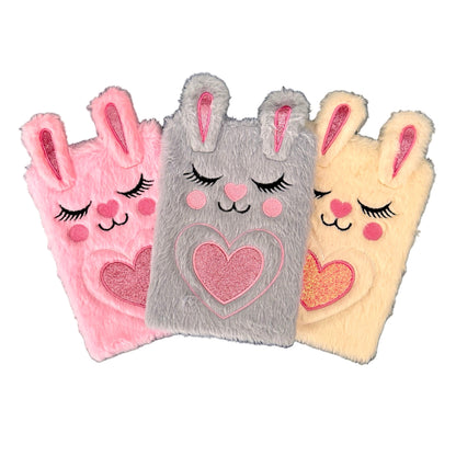Three plush journals with bunny designs.