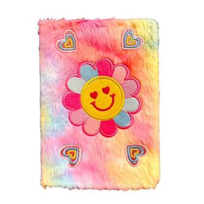 Fluffy rainbow colored notebook with a smiley face flower design and heart shapes on a white background