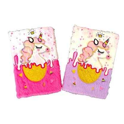 Two plush books with unicorn designs on a white background.