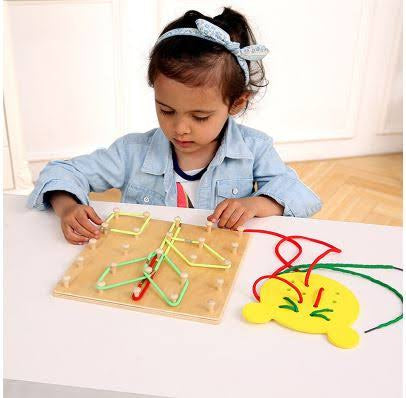 Child playing with educational toy on a white table