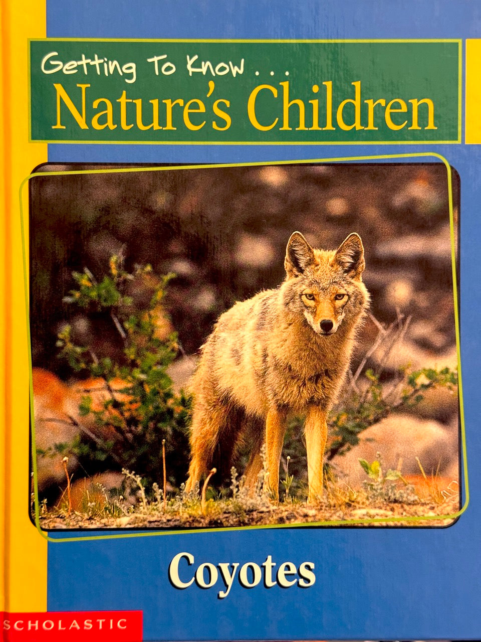 Book cover of 'Getting To Know Nature's Children: Coyotes' with a coyote illustration on a blue background.