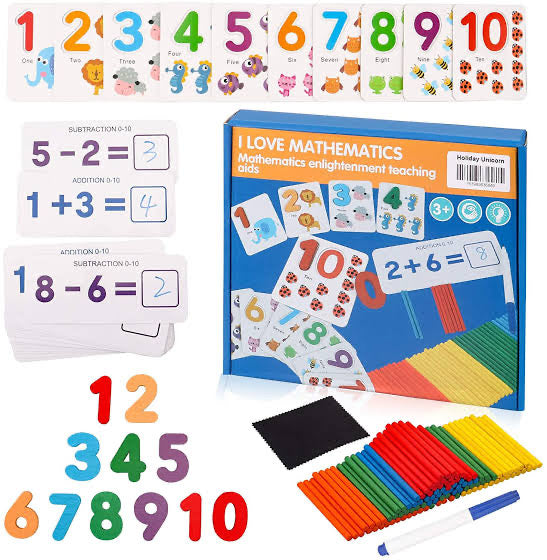 Educational math materials including number cards, a book titled 'I Love Mathematics', and colorful sticks with markers on a white background.