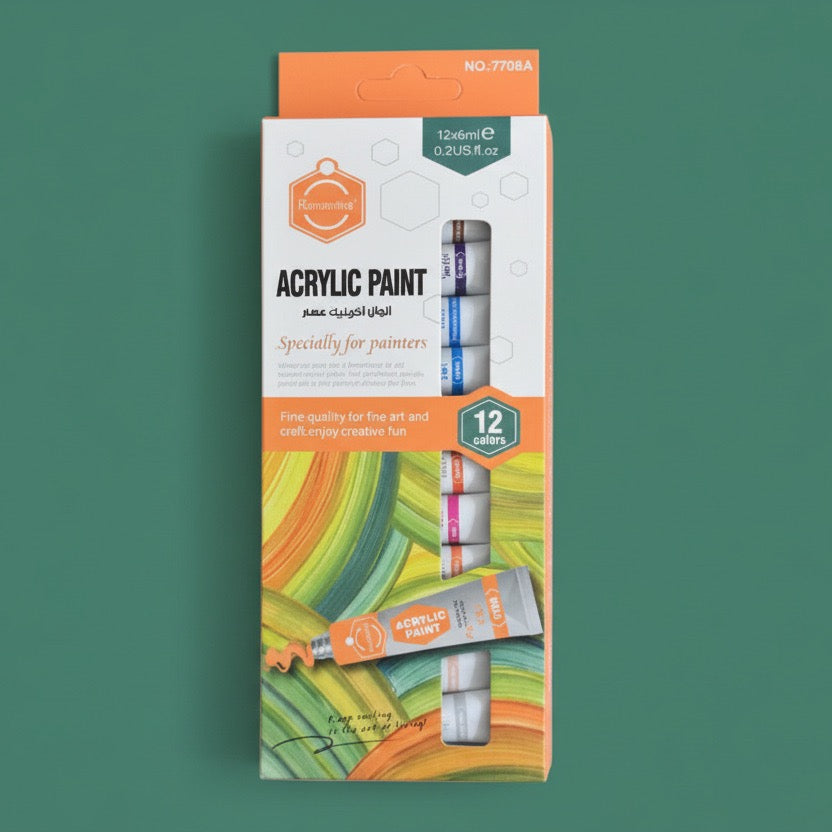 acrylic paint box of 12 colors on a green background