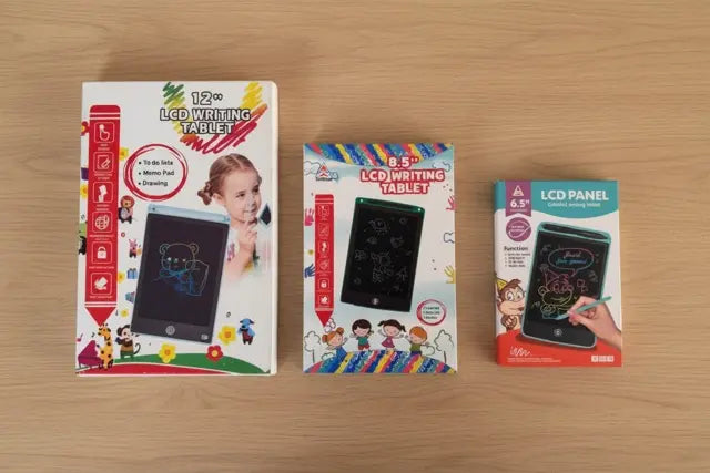 Three packaging boxes of LCD writing tablets on a wooden surface
