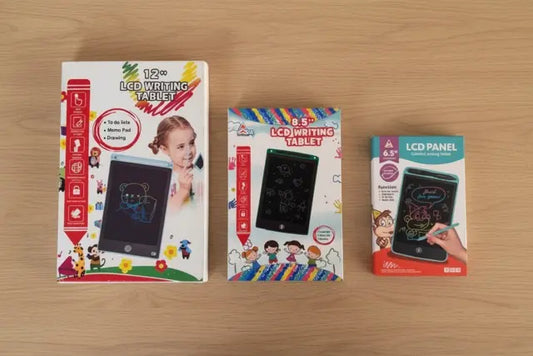 Three packaging boxes of LCD writing tablets on a wooden surface
