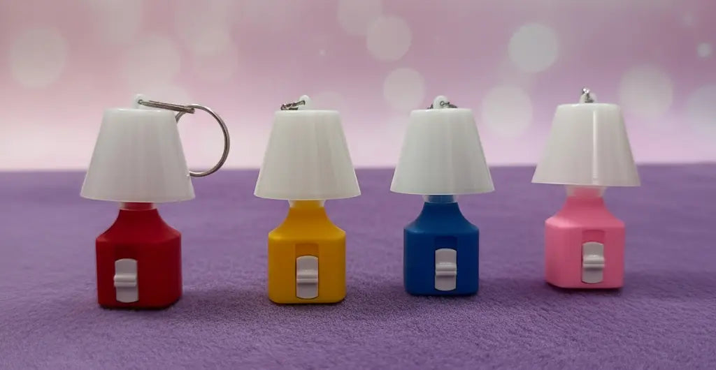 colored lamps keychains on a pink and purple background