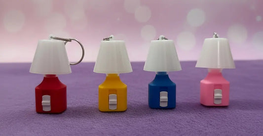 colored lamps keychains on a pink and purple background