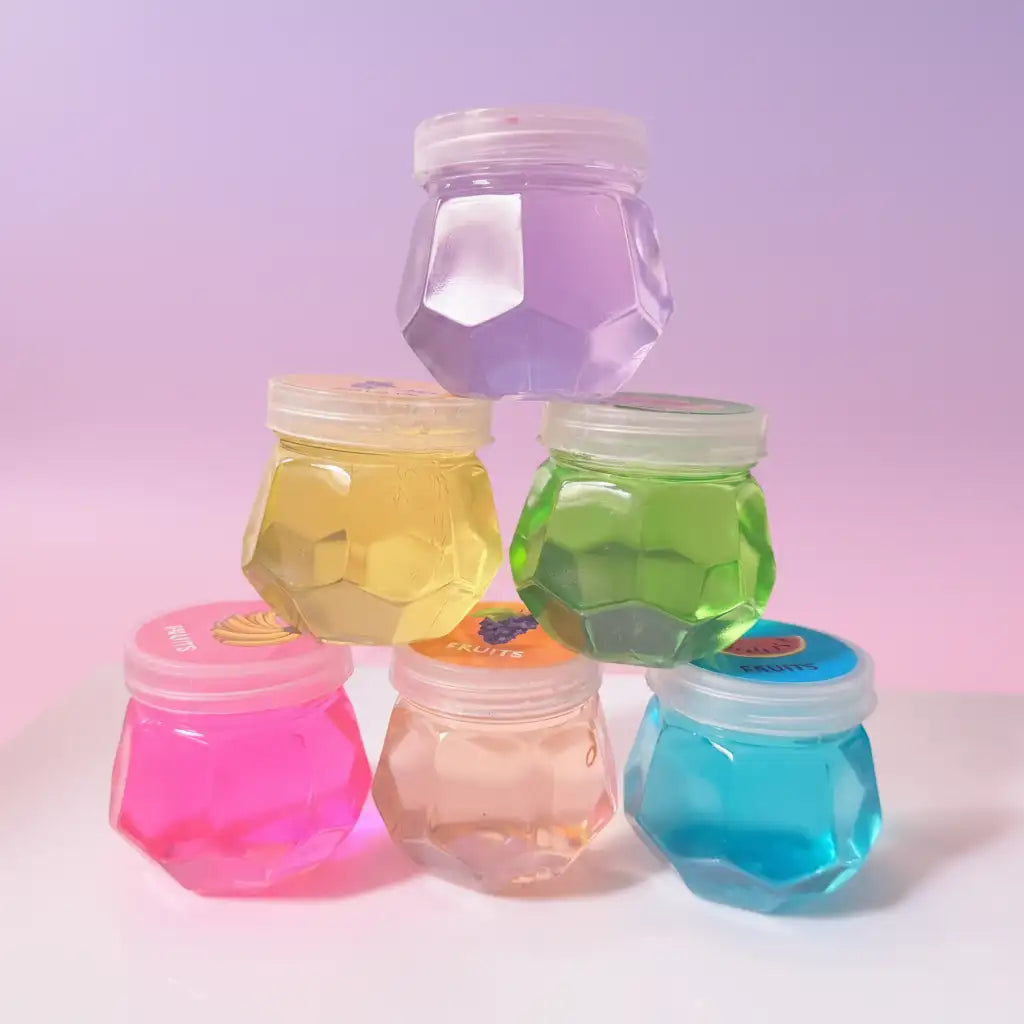 Colorful jelly jars with lids on a gradient background