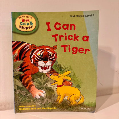 Book cover of 'I Can Trick a Tiger' from the Biff, Chip & Kipper series with a tiger and dog illustration.