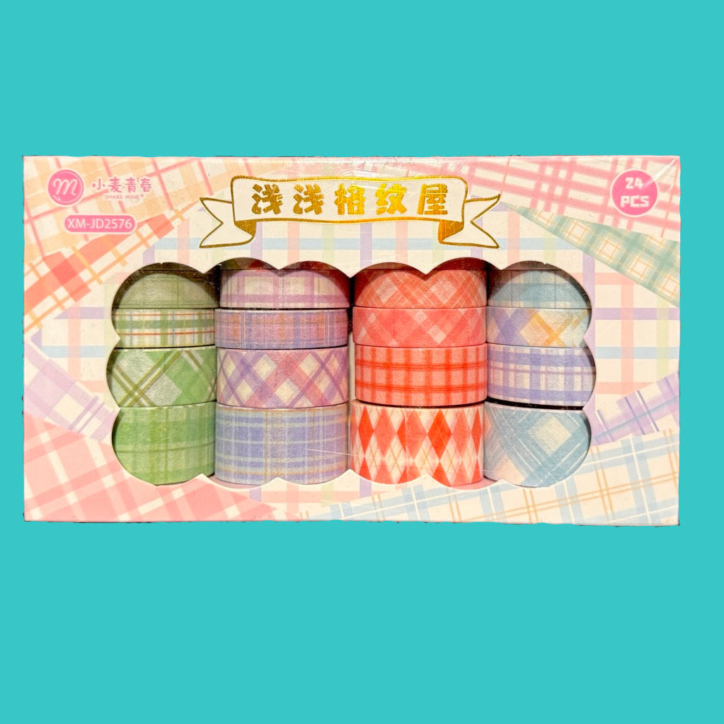 Set of colorful washi tape rolls in a decorative box on a blue background