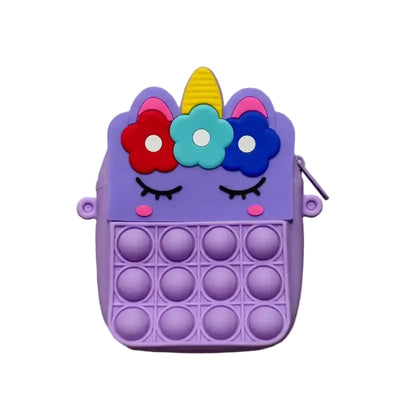 Purple unicorn pop-it fidget toy on a beige background
