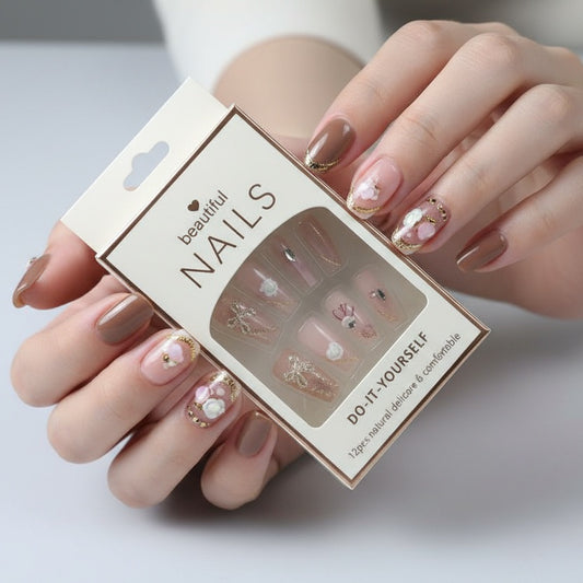 Nail art kit with a hand model displaying nail designs on a neutral background