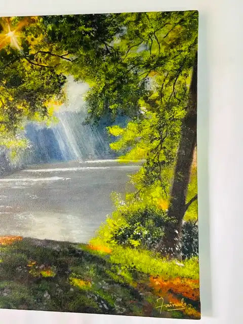 A vertical canvas painting of a scenic waterfall in a lush green forest, shown hanging on a white wall.