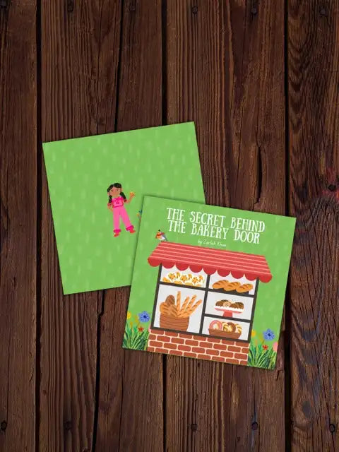 A children's book titled 'The Secret Behind the Bakery Door' by Zarlish Khan, displayed on a dark wood background. The book features a bright green cover with a small illustration of a girl in pink, and the front cover shows a colorful bakery storefront with illustrations of bread, pastries, and flowers.