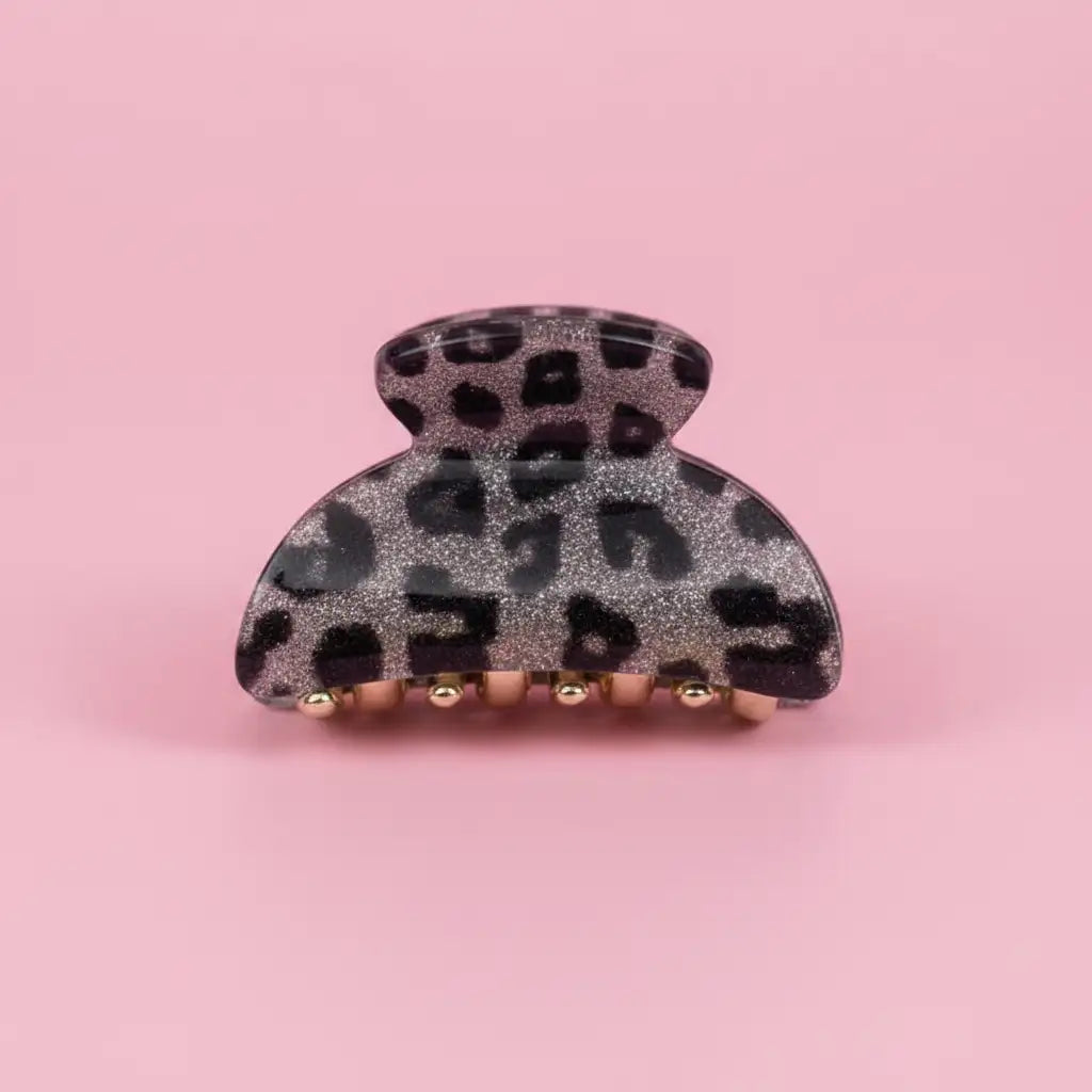 Leopard print hair clip on a pink background