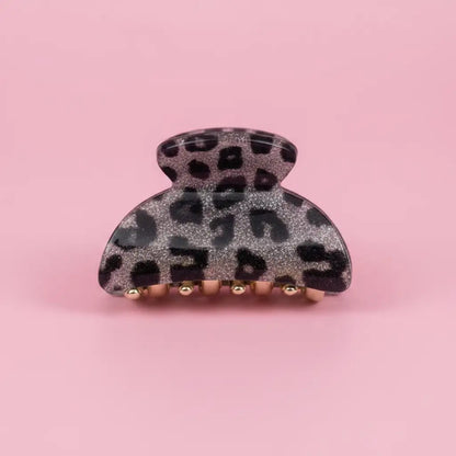 Leopard print hair clip on a pink background