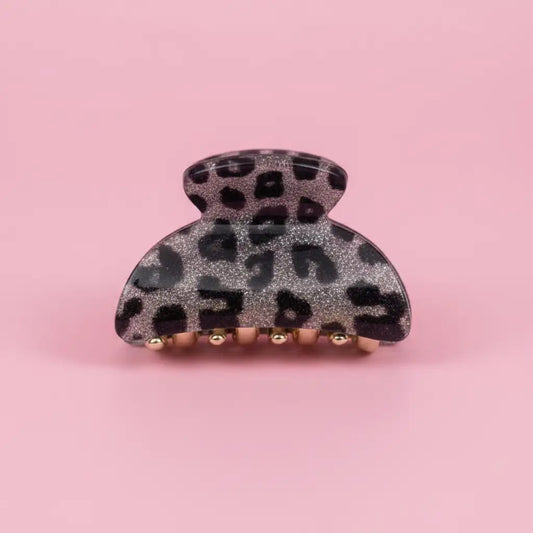 Leopard print hair clip on a pink background