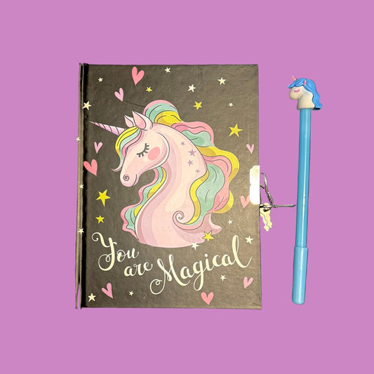 Notebook with unicorn illustration and 'You are Magical' text, accompanied by a blue pen with a unicorn design on a purple
 background.