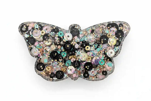 Butterfly-shaped squishy with multicolored sequins on a white background