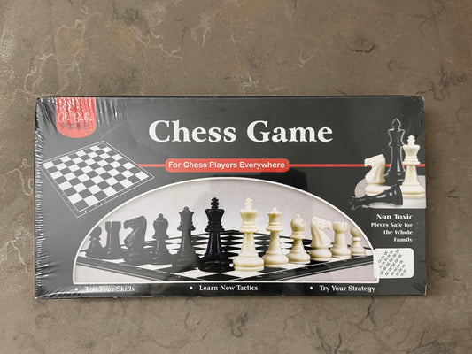 Chess game packaging with chess pieces and board on a textured surface