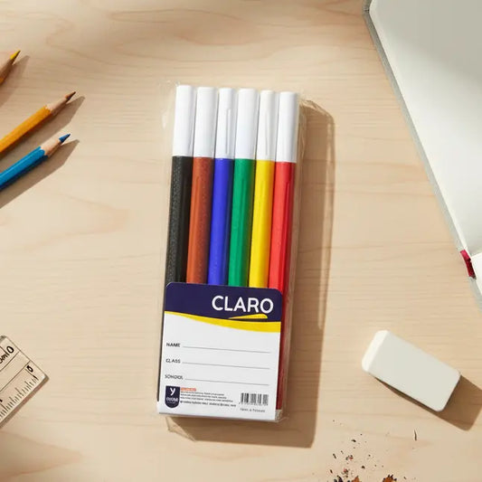 pack of colored markers on a light wood table with other stationery items